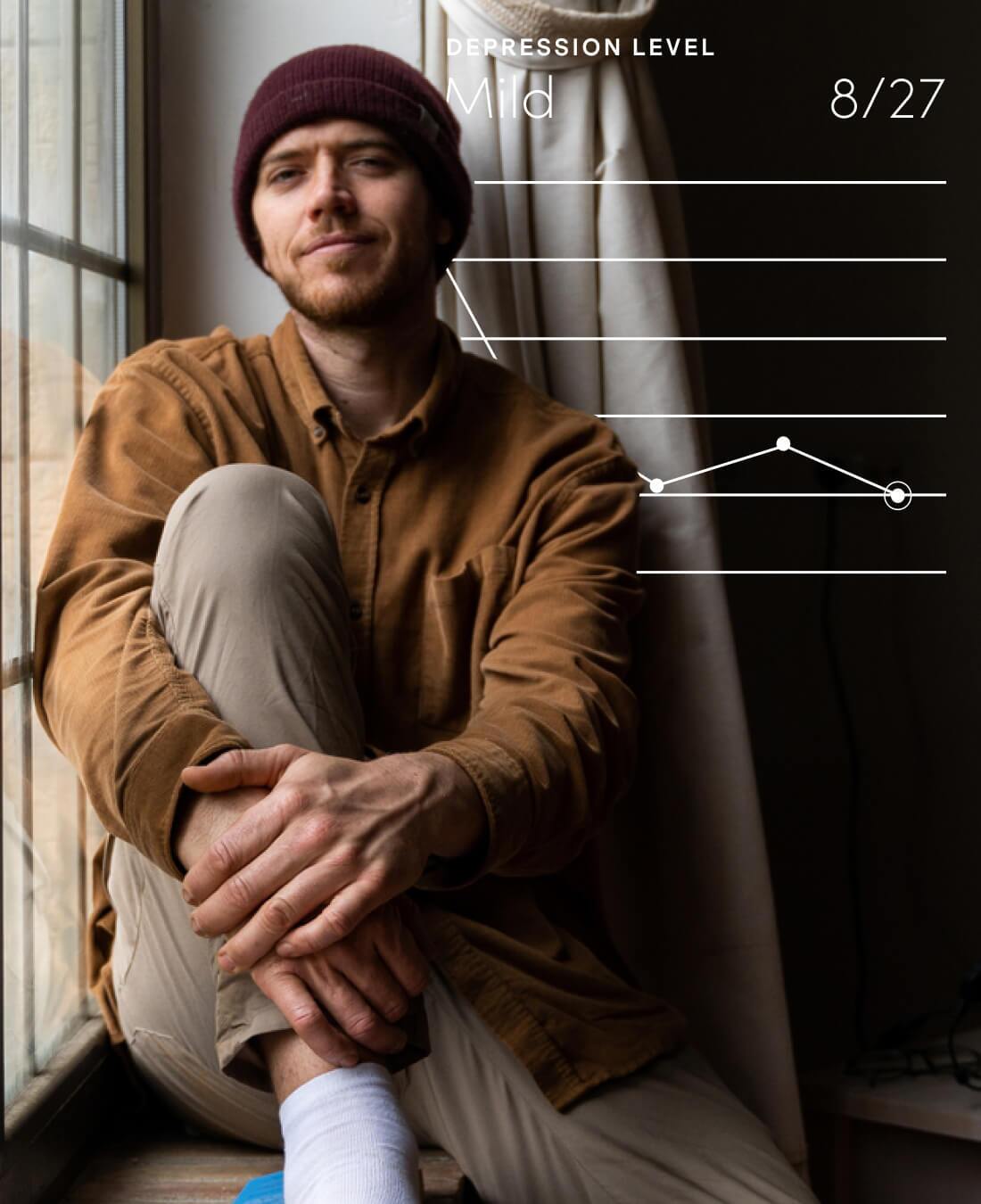 man sitting by a window and smiling