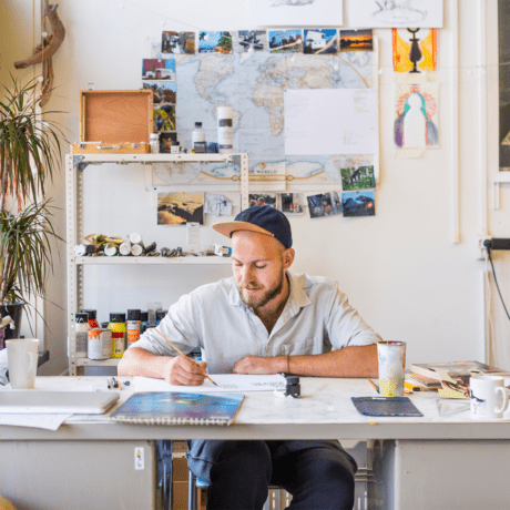 Artist At Work at a white desk