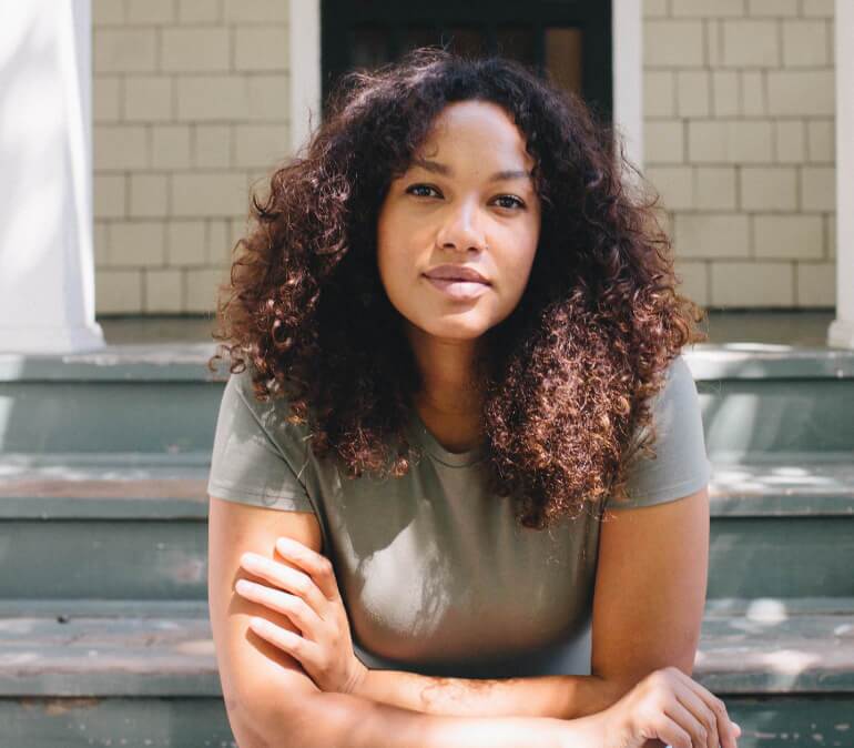 Smiling woman sitting on stairs