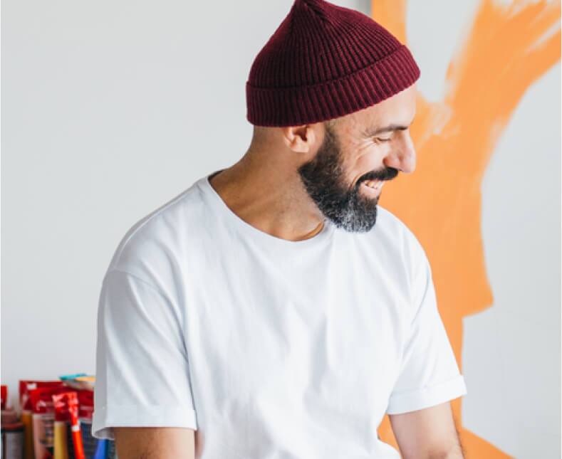 man sitting down and smiling