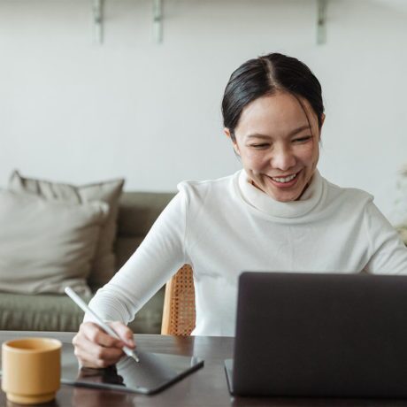 Woman laughing during a conversation with an online therapist