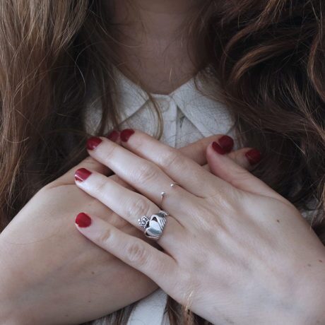 Close up of a woman with her hands on her chest suffering an anxiety attack