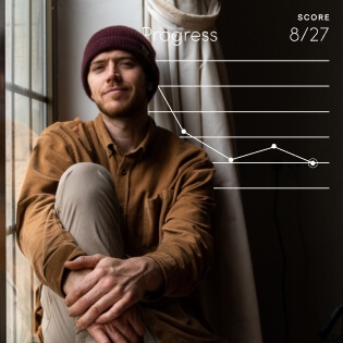 man sitting by a window and smiling