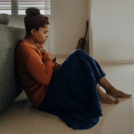 woman having a panic attack on the floor