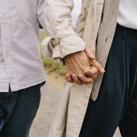 two people holding hands and walking