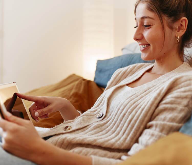 woman looking at phone and smiling