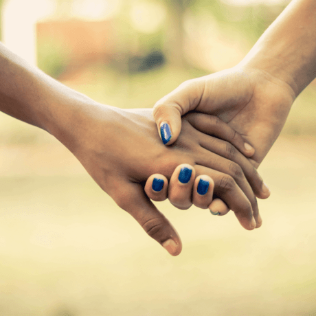 Close up of two people holding hands