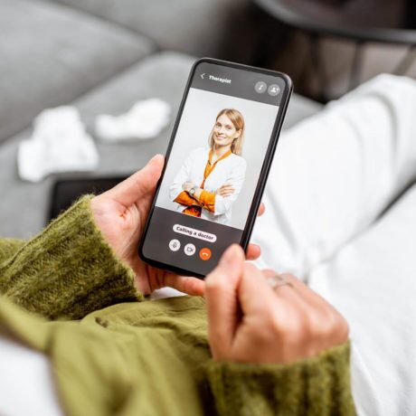 close up of a person having a video call with their therapist