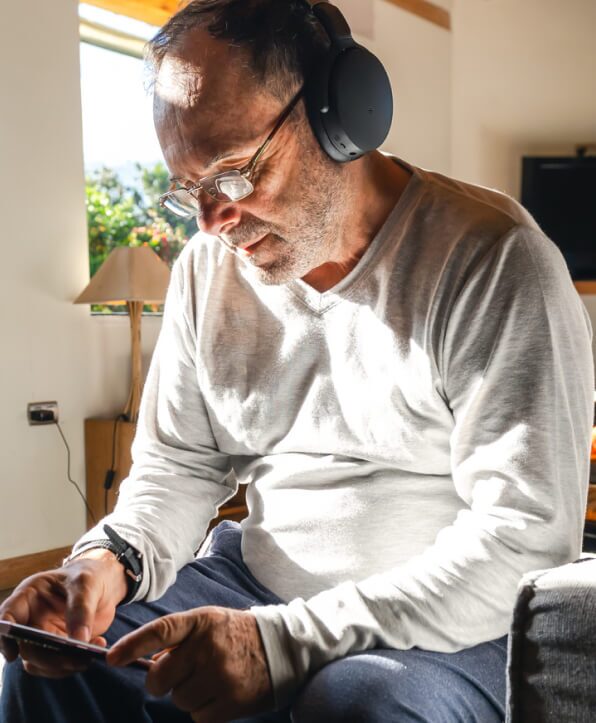 older man looking at phone and smiling