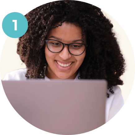 woman looking at her laptop and smiling