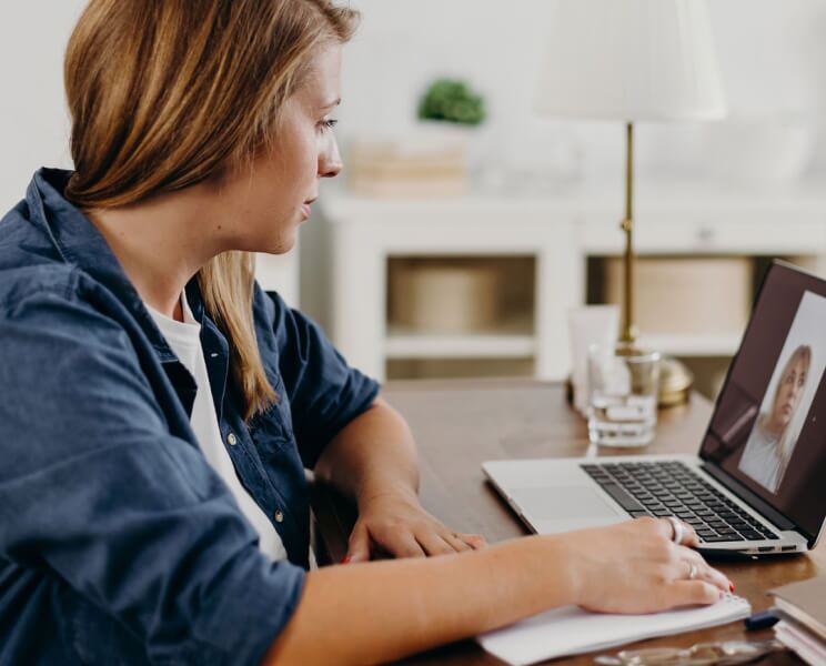 women on a video call on her laptop